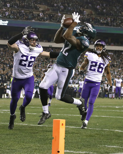 Philadelphia Eagles Torrey Smith catches a touchdown pass in front of Minnesota Vikings Trae Waynes (26) and Harrison Smith (22) during the second half of the NFL football NFC championship game Sunday, Jan. 21, 2018, in Philadelphia. (AP Photo/Matt Slocum)