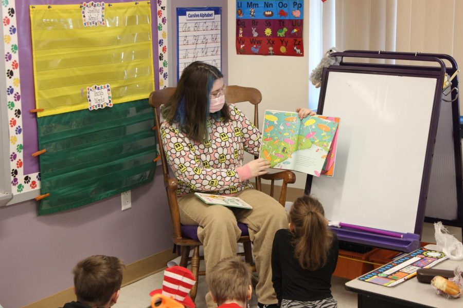 A senior at GNA reads to a class of elementary students on Dr. Seuss week. 