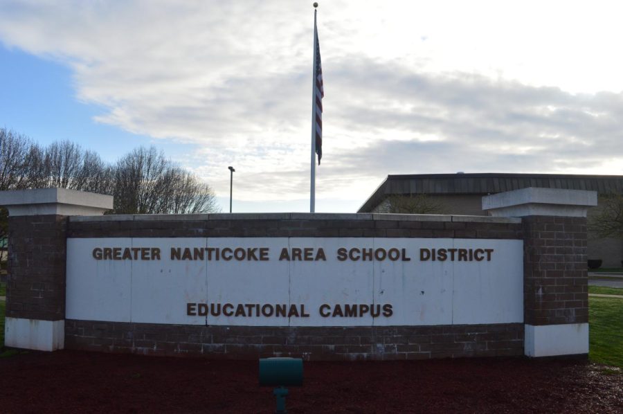 The American Flag ripples behind the Greater Nanticoke Area campus sign. 