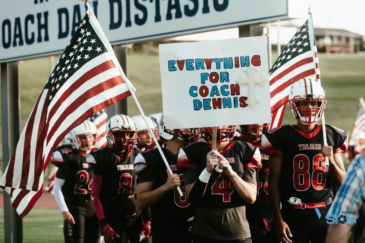 The Nanticoke Trojans displaying a poster made for Coach Dennis at the football game against North Pocono.